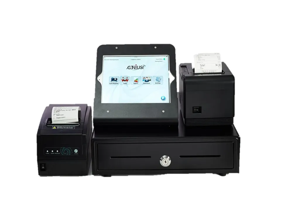 A GeniusPos counter setup photographed on white: an iPad in a stand running the app home menu, a cash drawer, and two receipt printers with dockets in them.