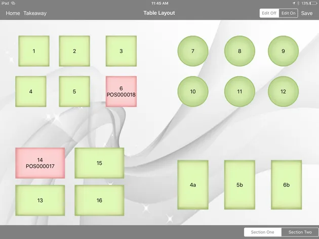 A floor plan on an iPad: tables of different shapes across two sections, most shaded green and two shaded pink.