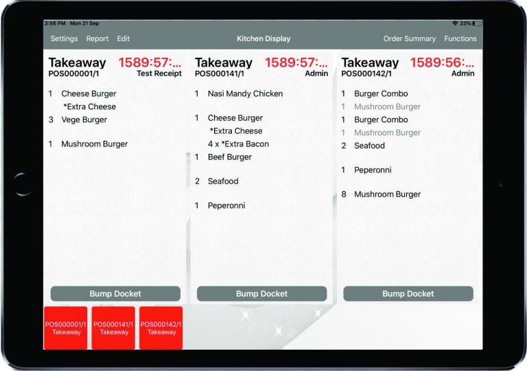 A GeniusPos kitchen display screen showing three takeaway order tickets with itemised food and modifier details.
